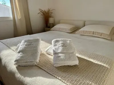 a bed with towels on top of it at Large 2 bedroom apartment, Close to Promenade des Anglais in Nice