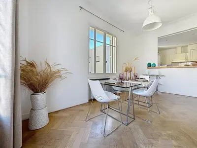 a dining room with a table and white chairs at Large 2 bedroom apartment, Close to Promenade des Anglais in Nice