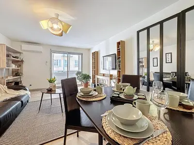 a dining room and living room with a table and chairs at One bedroom apartment with terrace , Port de Nice , ideal location in Nice