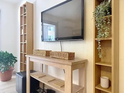 a flat screen tv hanging on a wall with a table at One bedroom apartment with terrace , Port de Nice , ideal location in Nice