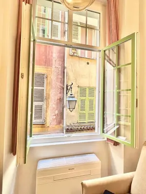a window with a view of a building at Superbe duplex proche cours Saleya in Nice
