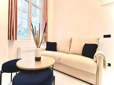 a living room with a couch and a table at Superbe duplex proche cours Saleya in Nice