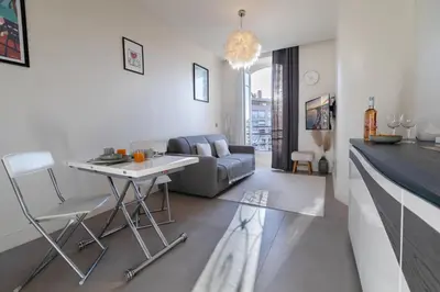 a living room with a table and a couch at Maison Bianchi - Studio on avenue Jean Medecin in Nice