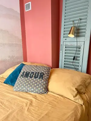 a bed with a pillow with a mom sign on it at Charming 2 rooms with balcony in Nice