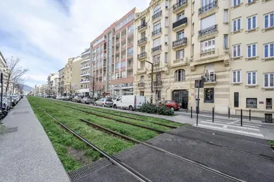 a street with cars parked on the side of a building at LX196 Studio mezzanine balcon Tram plage à pied in Nice