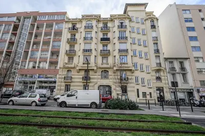 a red car parked on the side of a street at LX196 Studio mezzanine balcon Tram plage à pied in Nice