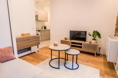 a living room with a table and two stools at Dolce Vita - Studio Centre Nice in Nice