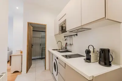 a white kitchen with a sink and a stove at Dolce Vita - Studio Centre Nice in Nice