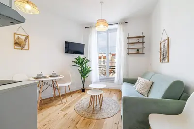 a living room with a couch and a table at Charming City Center Studio 402 in Nice