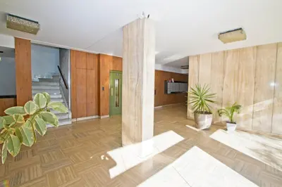 an office lobby with wooden walls and potted plants at Le Copacabana Riviera in Nice