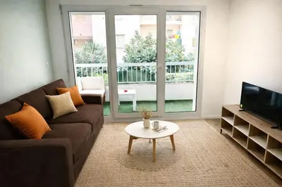 a living room with a couch and a coffee table at CALIF52 appartement avec terrasse à 3 min de la plage,1min tram in Nice