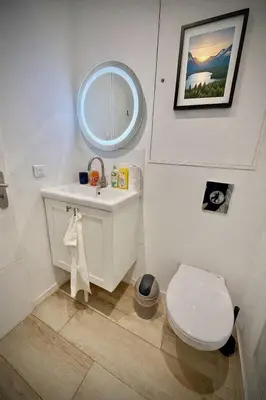 a bathroom with a toilet and a sink and a mirror at Charmant studio pour amoureux in Nice