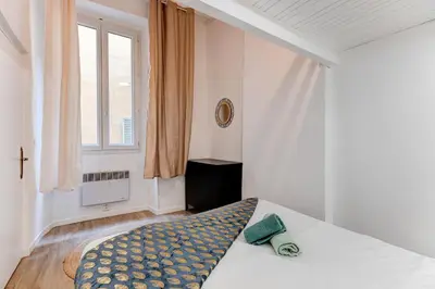 a bedroom with a bed and a window at Vieille Ville - parking, 5 pers, AC, WIFI in Nice