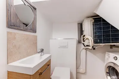 a bathroom with a sink and a washer and dryer at Vieille Ville - parking, 5 pers, AC, WIFI in Nice