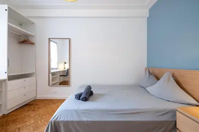 a bedroom with a large bed with a mirror at Chambre privée 1 personne BAIL MOBILITE in Nice