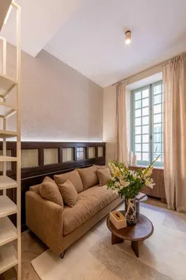 a living room with a brown couch and a book shelf at 2BDR 6P central A C apt - heart of Nice - Beach in Nice