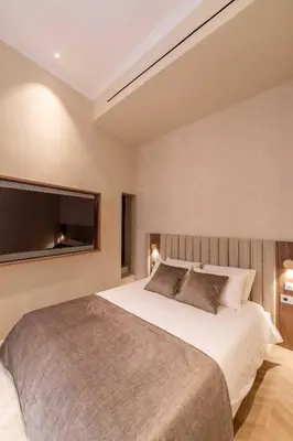 a bedroom with a large bed and a flat screen tv at 2BDR 6P central A C apt - heart of Nice - Beach in Nice