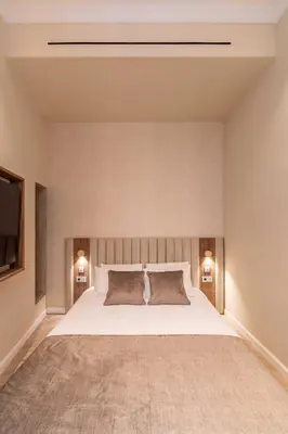 a bedroom with a large white bed and two lamps at 2BDR 6P central A C apt - heart of Nice - Beach in Nice