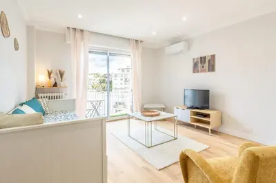 a living room with a couch and a tv at Nice - SweetHome Spacious Flat - Balcon in Nice