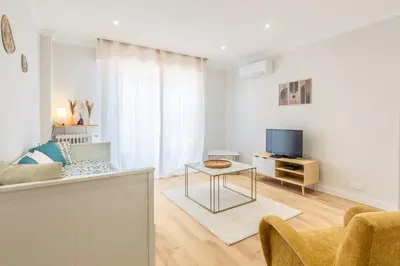 a living room with a couch and a tv at Nice - SweetHome Spacious Flat - Balcon in Nice