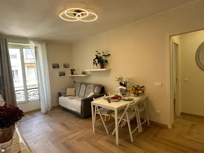 a living room with a table and a couch at Cozy Apartment in the heart of Nice in Nice