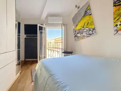 a white bedroom with a bed and a balcony at Calm & Cozy Cocoon Place Masséna Downtown in Nice