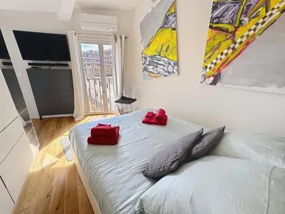 a bedroom with a bed with two red pillows on it at Calm & Cozy Cocoon Place Masséna Downtown in Nice