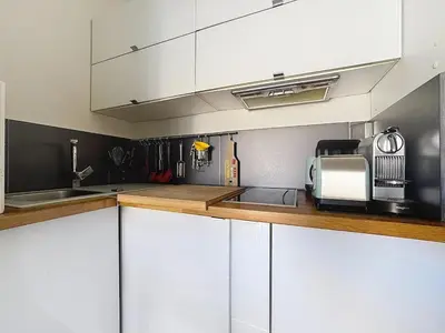 a kitchen with white cabinets and a microwave at Calm & Cozy Cocoon Place Masséna Downtown in Nice