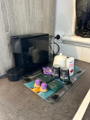 a glass table with cupcakes and a microwave at Studio Azur in Nice
