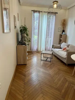 a living room with a couch and a table at A Sweet Escape for Two in Nice