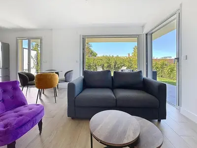 a living room with a couch and a table at Comfort and relaxation and swimming pool in Nice