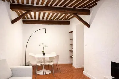 a dining room with a white table and chairs at Charme du Vieux-Nice - cocon lumineux à 100 m de la mer in Nice