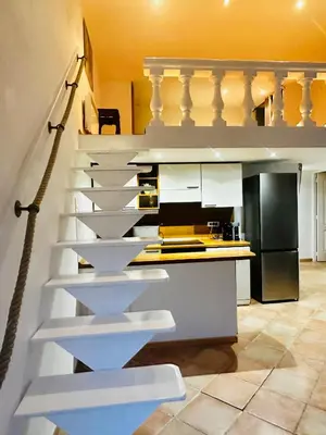 a staircase in a kitchen with white cabinets at Vieux Nice bord de mer in Nice
