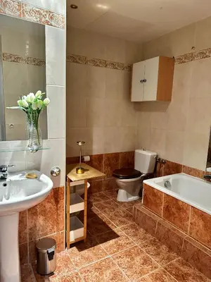 a bathroom with a tub and a toilet and a sink at Vieux Nice bord de mer in Nice