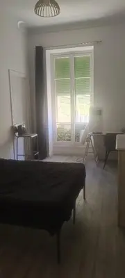 a bedroom with a bed and a window and a desk at plein centre Nice magnifique chambre double climatisée in Nice