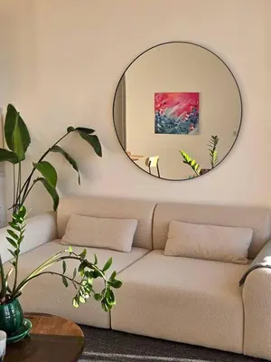 a living room with a couch and a mirror at Bright Artist's Apartment On Nice Hills in Nice