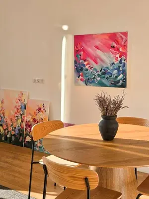 a dining room with a table and two paintings at Bright Artist's Apartment On Nice Hills in Nice