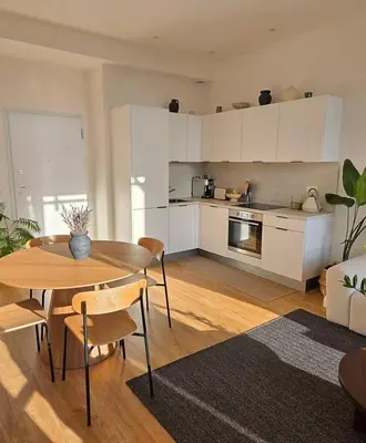 a kitchen and living room with a table and chairs at Bright Artist's Apartment On Nice Hills in Nice