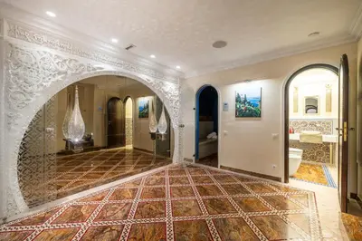 a large room with a tile floor and an archway at Villa Belle Epoque, sea view, pool & hammam in Èze