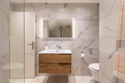a bathroom with a sink and a toilet and a mirror at Cagnes sur mer, 1 bedroom with Garden-Air conditioning-Wifi in Cagnes-sur-Mer