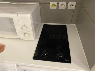 a microwave sitting on top of a white counter at Palais Des Domes Adagio Aparthotel in Nice