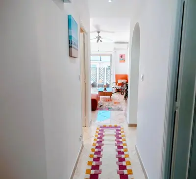 a hallway with a colorful rug on the floor at Modern Gem 200m from Beaches with Balcony, AC and Tram in Nice