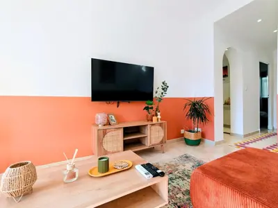 a living room with a flat screen tv on a wall at Modern Gem 200m from Beaches with Balcony, AC and Tram in Nice