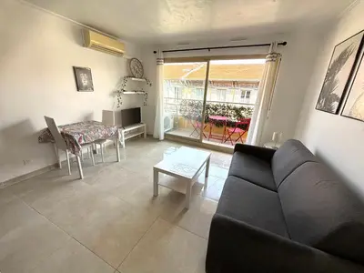 a living room with a couch and a table at Studio port plage in Nice