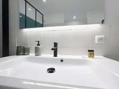 a white sink in a bathroom with a mirror at Séjour idéal au cœur du Vieux-Nice in Nice