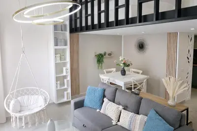 a living room with a couch and a table at Azur Carré d'or Duplex 6 pers 2 min de la mer in Nice