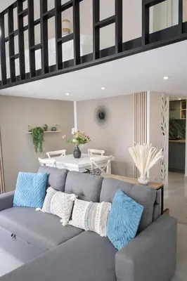 a living room with a gray couch and a table at Azur Carré d'or Duplex 6 pers 2 min de la mer in Nice