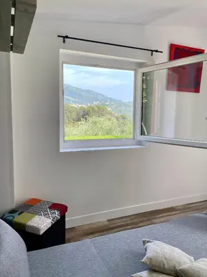 a bedroom with a bed and a sliding glass door at Casa Balija in Tourrette-Levens