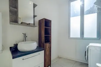 a bathroom with a sink and a mirror at Charmant studio cosy - Nice Est in Nice