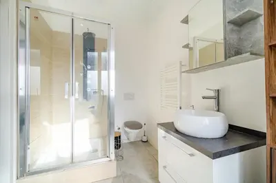 a bathroom with a glass shower and a sink at Charmant studio cosy - Nice Est in Nice